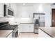 Contemporary kitchen with stainless steel appliances, granite countertops, and ample cabinet space at 3401 Arapahoe Ave # 105, Boulder, CO 80303