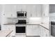 Stylish kitchen showcasing stainless steel appliances, white cabinetry, and elegant backsplash at 3401 Arapahoe Ave # 105, Boulder, CO 80303