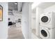 Convenient in-unit laundry area features a stacked washer and dryer near the open floor plan at 3401 Arapahoe Ave # 105, Boulder, CO 80303