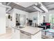 Open-concept living space featuring a kitchen island, office area, and comfortable seating at 3401 Arapahoe Ave # 105, Boulder, CO 80303