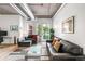 A bright living room offers a comfortable seating area and views from the windows at 3401 Arapahoe Ave # 105, Boulder, CO 80303