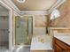 Bathroom with soaking tub and elegant shower with glass door and gold trim at 10954 W 100Th Way, Broomfield, CO 80021