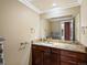 Bathroom vanity featuring granite countertops, dark cabinetry, and a large mirror and fixtures at 10954 W 100Th Way, Broomfield, CO 80021