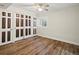 Clean bedroom with hardwood floors, modern sliding closet doors, and plantation shutters on the windows at 10954 W 100Th Way, Broomfield, CO 80021