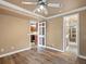 Bedroom featuring wood-look flooring, bright crown molding, and paneled doors to other rooms at 10954 W 100Th Way, Broomfield, CO 80021