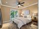 Bright bedroom with a ceiling fan, neutral walls, and sliding doors to a private balcony at 10954 W 100Th Way, Broomfield, CO 80021