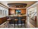 Inviting kitchen bar with stylish seating, a mounted TV, and an open view of the home at 10954 W 100Th Way, Broomfield, CO 80021