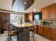 Spacious kitchen bar area with ample seating, granite countertops, and modern appliances at 10954 W 100Th Way, Broomfield, CO 80021