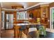 Detailed view of the kitchen's granite counters, copper backsplash, modern appliances, and breakfast bar at 10954 W 100Th Way, Broomfield, CO 80021