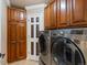 Laundry room equipped with modern washer and dryer units and ample cabinet space at 10954 W 100Th Way, Broomfield, CO 80021