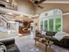 Open-concept living room that features vaulted ceilings, large windows, and a view into the kitchen at 10954 W 100Th Way, Broomfield, CO 80021