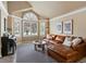 Bright living room with large windows, modern decor, and comfortable seating at 10954 W 100Th Way, Broomfield, CO 80021