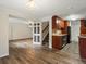 An open living space with new flooring, a partial kitchen, and a stairwell leading upstairs at 10954 W 100Th Way, Broomfield, CO 80021
