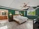 Bright main bedroom boasts green walls, tile floor, and an en suite bathroom with double vanity and wooden cabinets at 10954 W 100Th Way, Broomfield, CO 80021