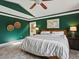 Spacious main bedroom features unique architecture, neutral tile flooring, and calming green walls at 10954 W 100Th Way, Broomfield, CO 80021