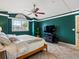 Beautiful main bedroom with neutral tile flooring, ceiling fan, and large bright window at 10954 W 100Th Way, Broomfield, CO 80021