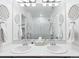 Bright bathroom features double sinks, mirrors, and a shower with glass doors at 17616 Bluetrail Ave, Parker, CO 80134