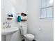 Clean powder bathroom features a pedestal sink, toilet, and neutral decor at 17616 Bluetrail Ave, Parker, CO 80134