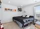 Simple bedroom with a black bed, posters on the wall, and natural light from the window at 17616 Bluetrail Ave, Parker, CO 80134