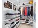 Organized walk-in closet featuring shelves, drawers, hanging racks, and ample storage space at 17616 Bluetrail Ave, Parker, CO 80134