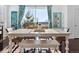 Bright dining area with large window, modern table and bench seating perfect for gatherings at 17616 Bluetrail Ave, Parker, CO 80134