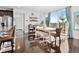 Bright dining room with a large window, a wooden table and chairs, and hardwood floors at 17616 Bluetrail Ave, Parker, CO 80134