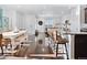 Bright open-concept living space with hardwood floors, a dining table and bar seating at 17616 Bluetrail Ave, Parker, CO 80134