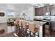 Open-concept kitchen with a large island, granite countertops, stainless appliances and bar seating at 17616 Bluetrail Ave, Parker, CO 80134