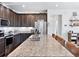 Modern kitchen with stainless appliances, a central island with seating, and generous countertop space at 17616 Bluetrail Ave, Parker, CO 80134