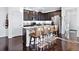 Modern kitchen with granite countertops, dark cabinets, and a spacious island with bar seating at 17616 Bluetrail Ave, Parker, CO 80134