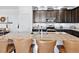Gourmet kitchen features a large island with bar seating, stainless steel appliances, and modern finishes at 17616 Bluetrail Ave, Parker, CO 80134