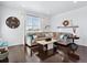 Comfortable living room with hardwood floors, a large window with natural light, and modern decor at 17616 Bluetrail Ave, Parker, CO 80134