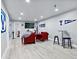 Basement living room with red chairs and a large screen television at 17616 Bluetrail Ave, Parker, CO 80134