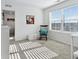 Bright room showcasing a rocking chair, artwork, and ample sunlight through a large window at 17616 Bluetrail Ave, Parker, CO 80134