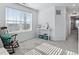 Bright room featuring a rocking chair, a console table with storage, and large window views at 17616 Bluetrail Ave, Parker, CO 80134