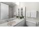 Modern bathroom with marble countertop, sleek fixtures, and a glass-enclosed shower at 1201 N Williams St # 16A, Denver, CO 80218