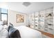 Bright bedroom featuring custom built-in shelving and city views at 1201 N Williams St # 16A, Denver, CO 80218