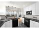 Well-lit kitchen featuring black countertops and stainless-steel appliances at 1201 N Williams St # 16A, Denver, CO 80218