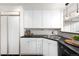 Well-appointed kitchen with ample cabinet space, black countertops, and stainless-steel sink at 1201 N Williams St # 16A, Denver, CO 80218