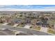 An aerial view shows the well-maintained homes and landscaping in the neighborhood, surrounded by green spaces and trees at 7154 E 131St Pl, Thornton, CO 80602