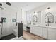Modern bathroom features a glass shower, wood-look floors, white countertops, and black hardware fixtures at 7154 E 131St Pl, Thornton, CO 80602