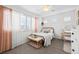 Inviting bedroom featuring a metal bed frame, soft textiles, and a well-lit vanity area for a calming ambiance at 7154 E 131St Pl, Thornton, CO 80602