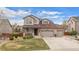 Charming two-story home with a three car garage, stone accents, landscaped yard and covered front porch at 7154 E 131St Pl, Thornton, CO 80602