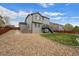Back exterior view of a two-story home shows the outdoor living space and low-maintenance landscaping, a perfect home at 7154 E 131St Pl, Thornton, CO 80602
