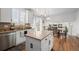 Open floor plan showcases a kitchen with an island, stainless appliances, and view to dining and living area at 7154 E 131St Pl, Thornton, CO 80602