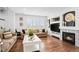 Stylish living room with fireplace, built-in shelving, and hardwood floors at 7154 E 131St Pl, Thornton, CO 80602