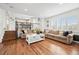 Bright living room with fireplace, hardwood floors, and cozy seating at 7154 E 131St Pl, Thornton, CO 80602