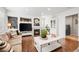 Living room with fireplace, built-in shelving, and hardwood floors at 7154 E 131St Pl, Thornton, CO 80602