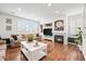 Inviting living room with fireplace, built-in shelving, and natural light at 7154 E 131St Pl, Thornton, CO 80602