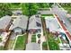 A residential aerial shot highlighting backyard gardens, patios, and solar panels amidst green lawns and mature trees at 3611 N Vine St, Denver, CO 80205
